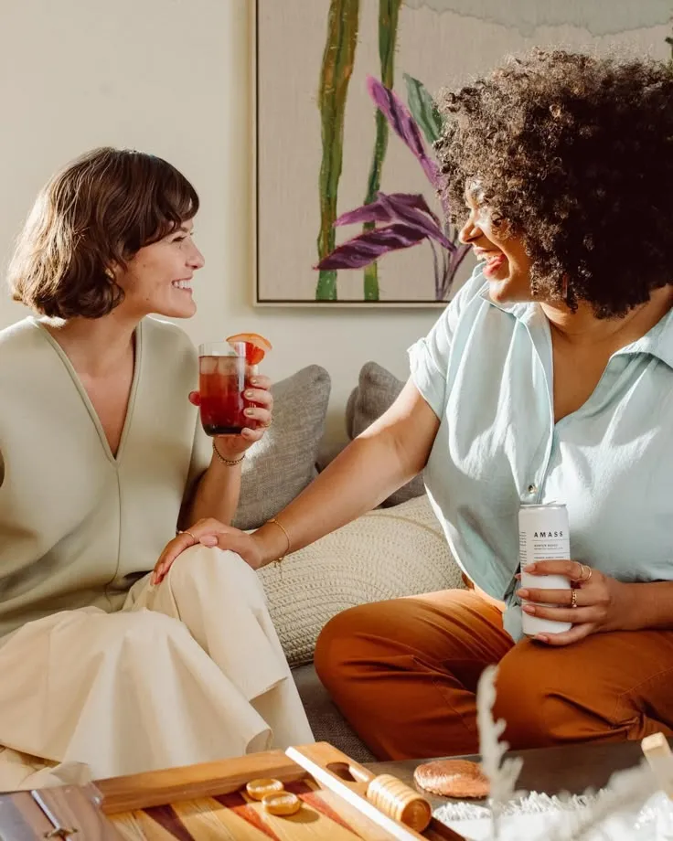 Two friends at home for a drink