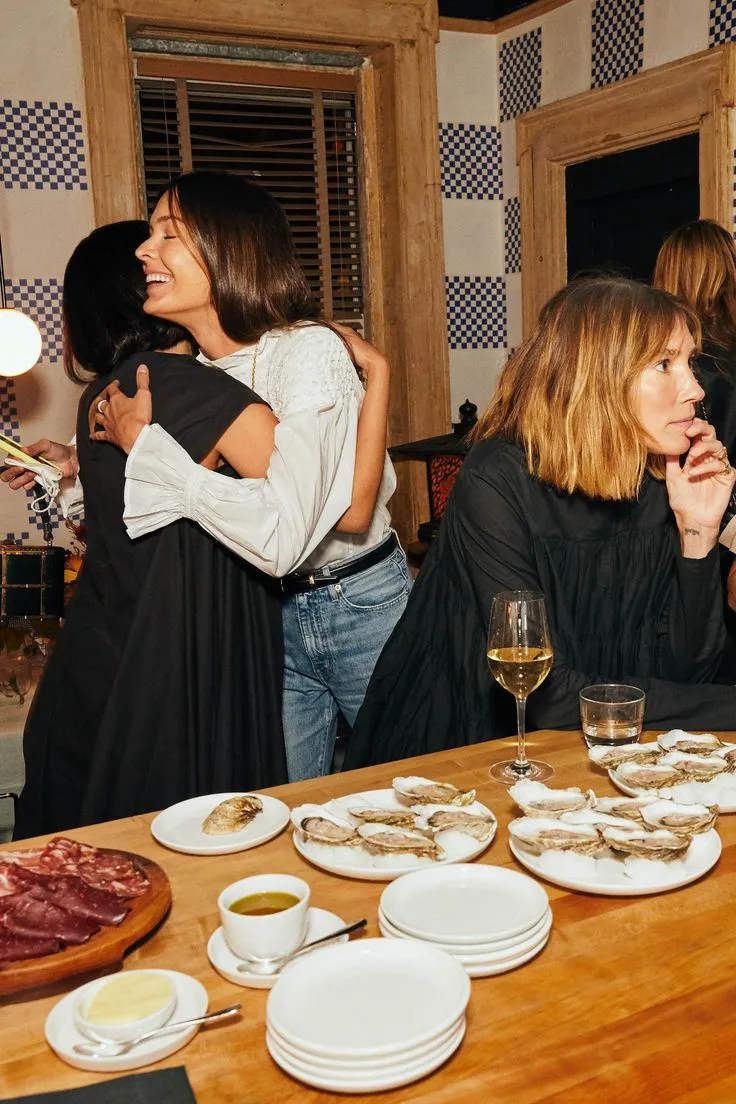 Social gather, two women hugging